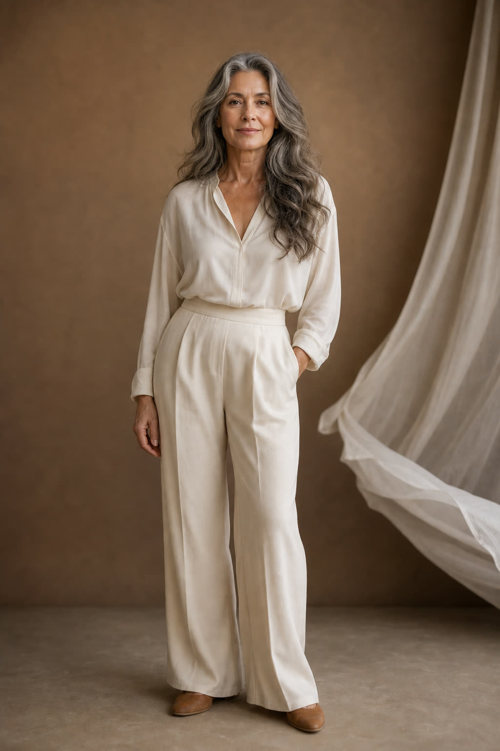 A woman with beautiful silver-streaked waves smiling with serene confidence
