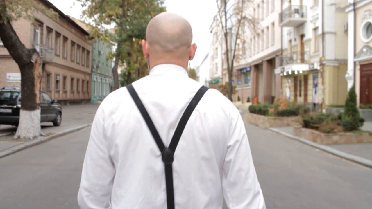 A woman walking through a city street with unhurried confidence