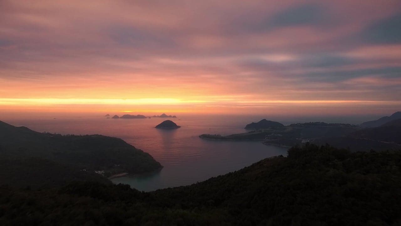 The ocean at dawn, seen from above, in pale gold light