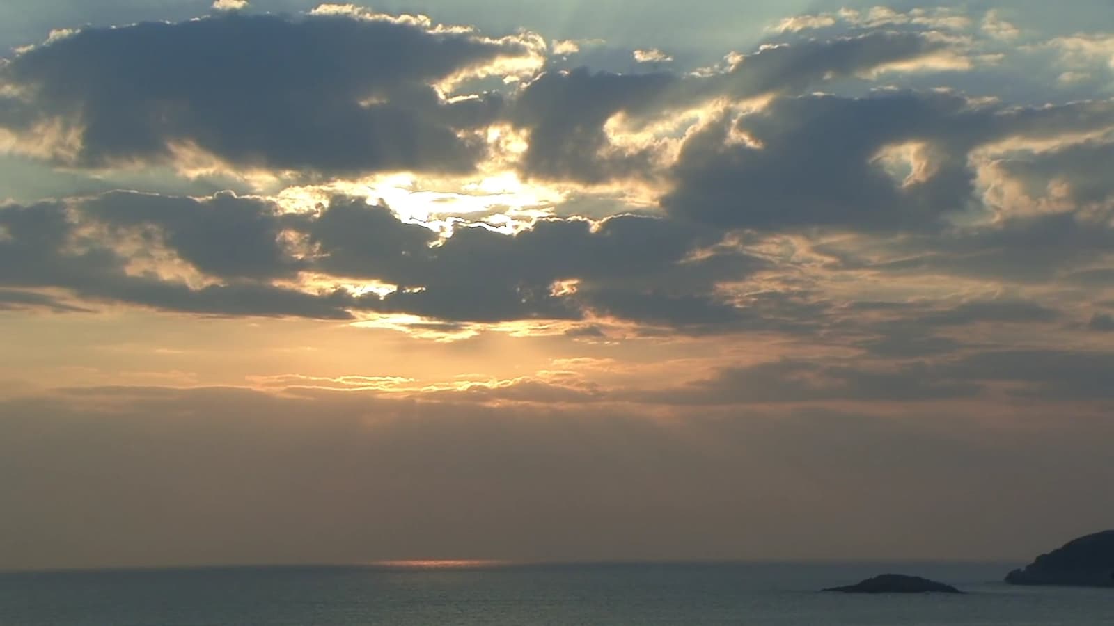 A pastel sky in slow motion, clouds drifting through lavender and peach light